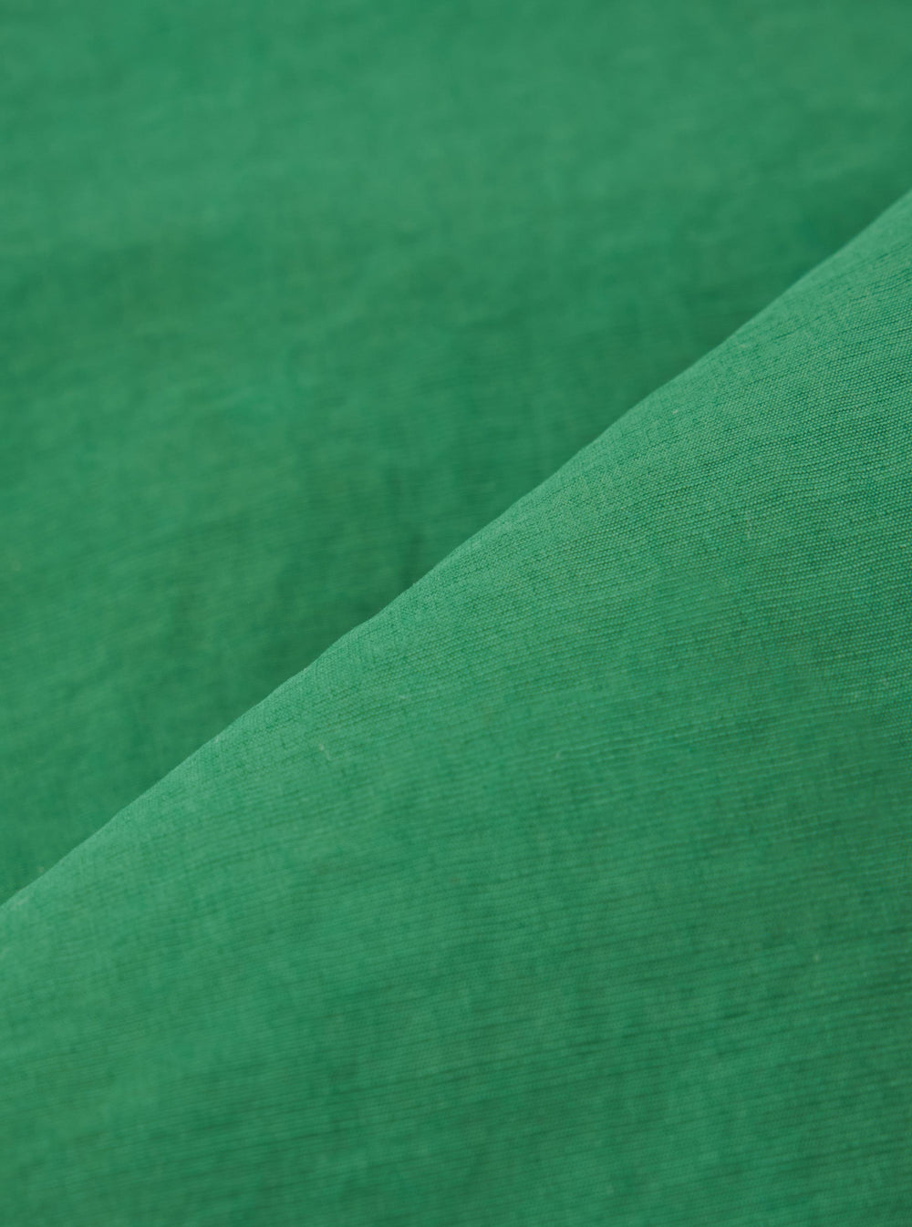 A close-up swatch image of the Green Recycled Splash Nylon Longsands Jacket fabric. The image focuses on the textile detail, showing a solid green color with a smooth, matte technical finish characteristic of recycled splash nylon.