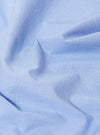 A close-up swatch image of the Sky Fil A Fil Camp Shirt fabric displays a light sky blue color with a fine, two-tone end-on-end weave. The texture of the cotton material is clearly visible, filling the frame against a neutral background.