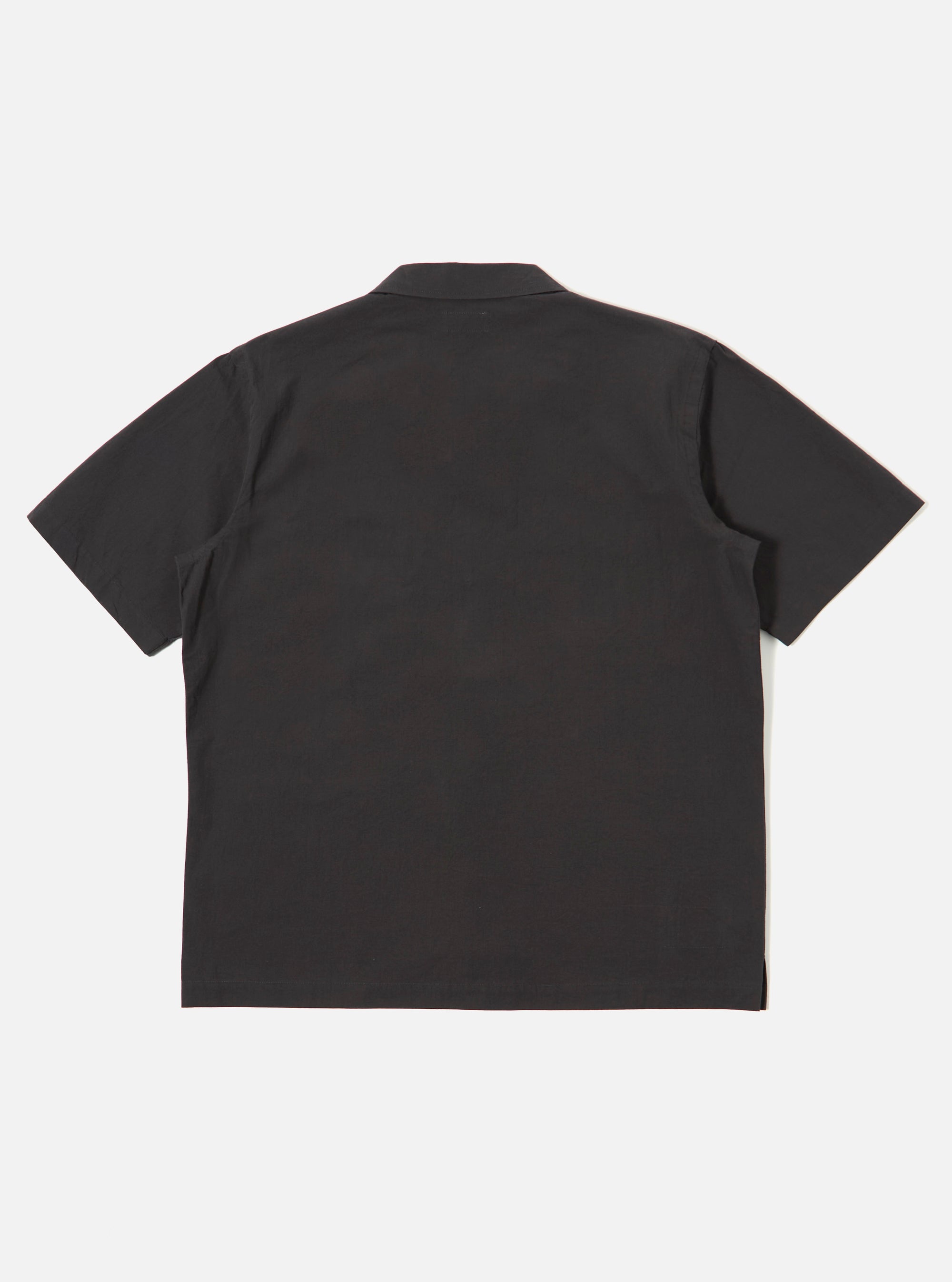The Black Tech Cotton S/S Dwight Overshirt is shown from the back as a flat lay against a plain white background. The image highlights the garment's clean back panel, short sleeves, and straight hem.