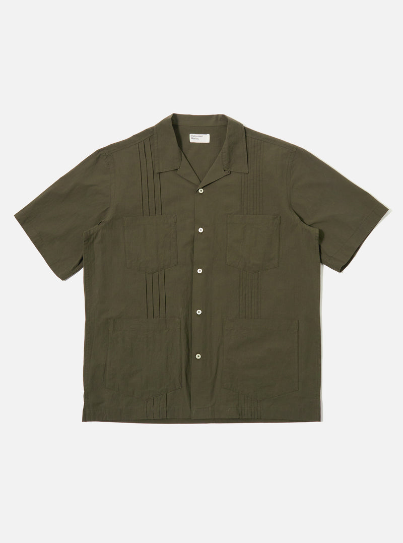 The Olive Tech Cotton S/S Dwight Overshirt is shown as a flat lay against a white background. The short-sleeved overshirt features a camp collar, a six-button front closure, and four front patch pockets. Two rows of vertical pleats are sewn down the front on either side of the buttons. The garment is made from a smooth olive green cotton fabric with a straight hem.