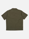 The Olive Tech Cotton S/S Dwight Overshirt is shown from the back as a flat lay against a plain white background. The image highlights the garment's clean lines, short sleeves, and straight hem in a solid olive green tech cotton fabric.