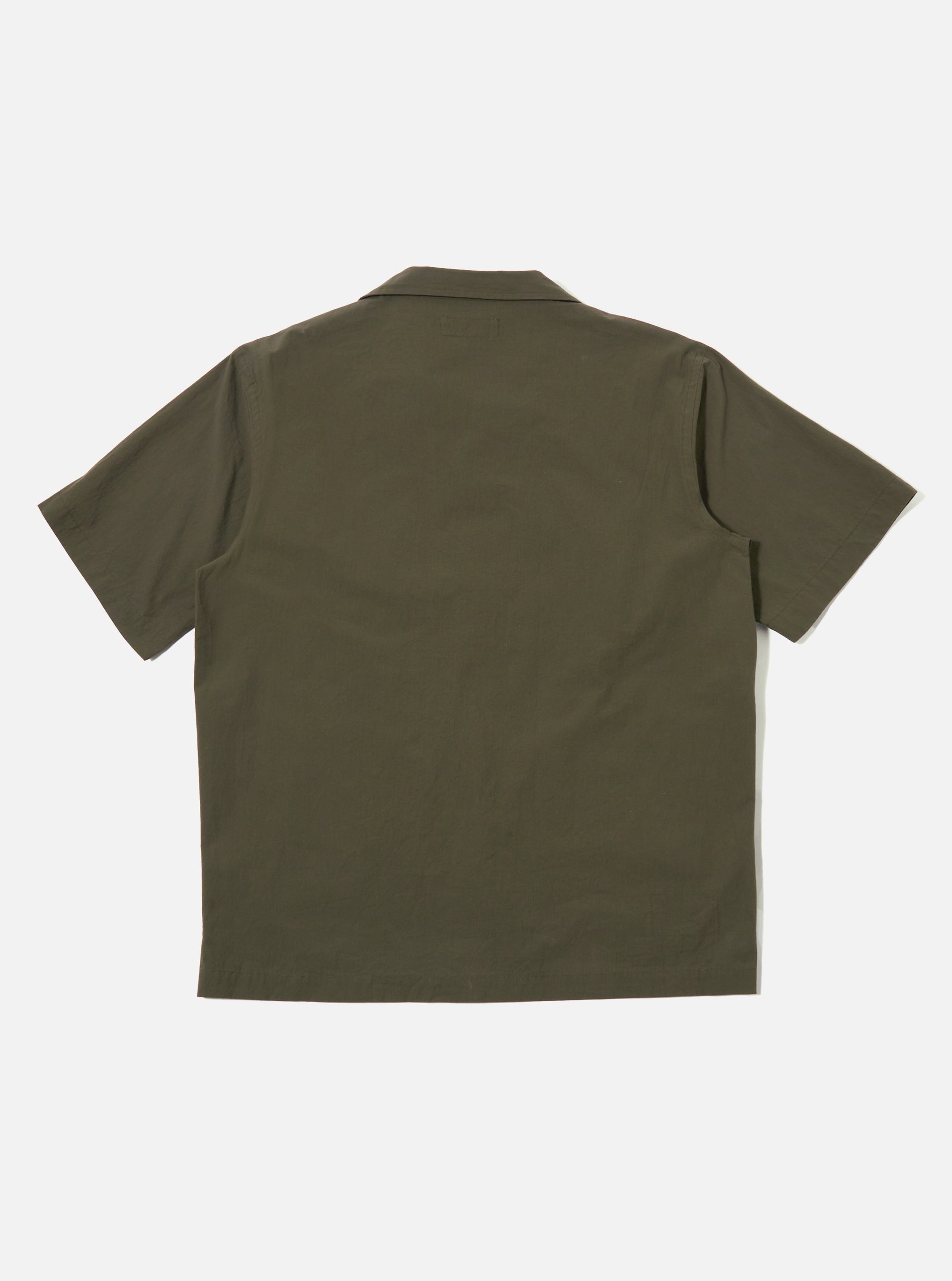 The Olive Tech Cotton S/S Dwight Overshirt is shown from the back as a flat lay against a plain white background. The image highlights the garment's clean lines, short sleeves, and straight hem in a solid olive green tech cotton fabric.
