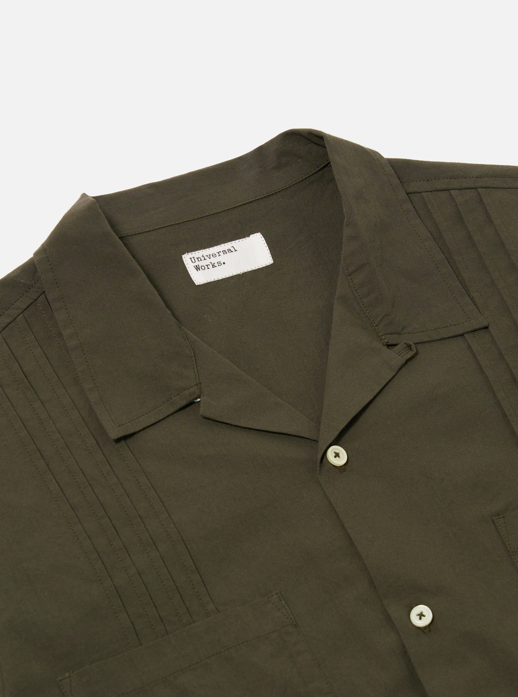 The Olive Tech Cotton S/S Dwight Overshirt is shown from the back as a flat lay against a plain white background. The image highlights the straight hem, short sleeves, and the smooth texture of the olive green cotton fabric.