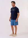 The Navy Single Jersey 34 Printed Core Tee is shown as a flat lay against a plain white background. The t-shirt features a crew neckline, short sleeves, and a white graphic print on the center chest. The fabric is a smooth navy blue cotton jersey.