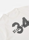 The Ecru Single Jersey 34 Printed Core Tee is shown from a rear angle as a flat lay against a plain white background. The image highlights the smooth ecru cotton fabric and the clean construction of the back panel and short sleeves.