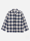 The Navy Texture Plaid Cancun Jacket is shown as a flat lay against a plain white background. The jacket features a structured collar, a central button-down closure, and four large patch pockets on the front. The navy blue cotton fabric has a distinct textured plaid pattern throughout.