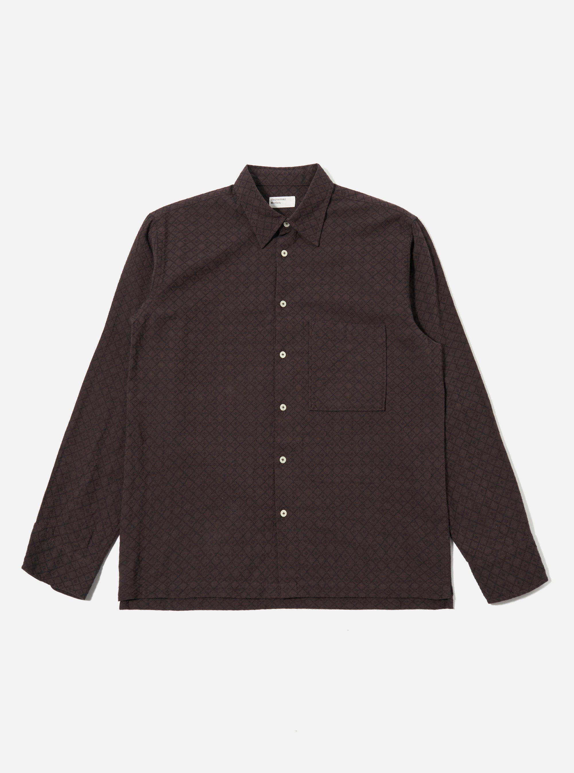 The Brown Diamond Dobby Lucky Shirt is shown as a flat lay against a white background. The shirt features a button-front fastening, a classic collar, and a single patch pocket on the left chest. The brown cotton fabric has a visible textured diamond dobby pattern throughout.
