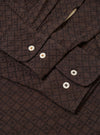 The Brown Diamond Dobby Lucky Shirt is shown from a rear angle as a flat lay against a plain white background. The image highlights the shirt's loose fit, straight hem, and the intricate diamond dobby pattern across the brown cotton fabric.