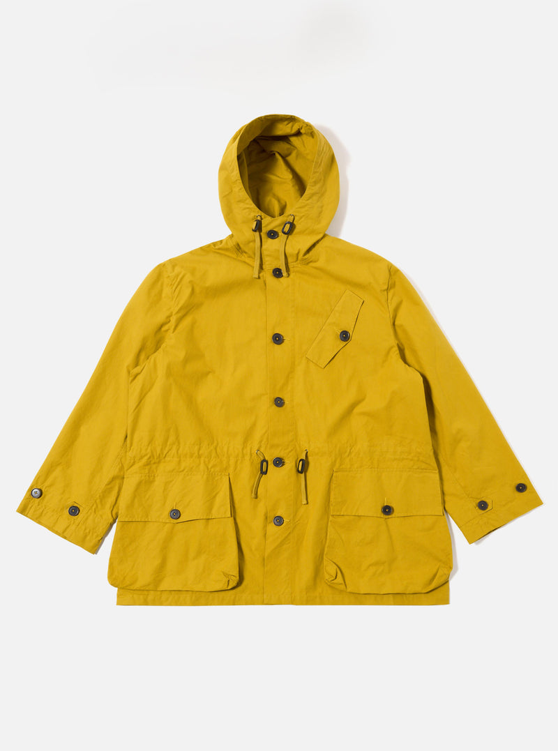 The Yellow British Wax Cotton Boston Parka is shown as a flat lay against a white background. The parka features a prominent oversized hood, a central button-down storm flap, and two large 3D patch pockets at the waist. The vibrant yellow fabric has a matte, waxed finish.