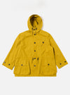 The Yellow British Wax Cotton Boston Parka is shown as a flat lay against a white background. The parka features a prominent oversized hood, a central button-down storm flap, and two large 3D patch pockets at the waist. The vibrant yellow fabric has a matte, waxed finish.
