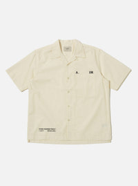 The A. SOCIETY x Universal Works Ecru Broadcloth Camp Shirt is laid flat on a white background. The shirt is a light cream color with short sleeves and a button-up front.