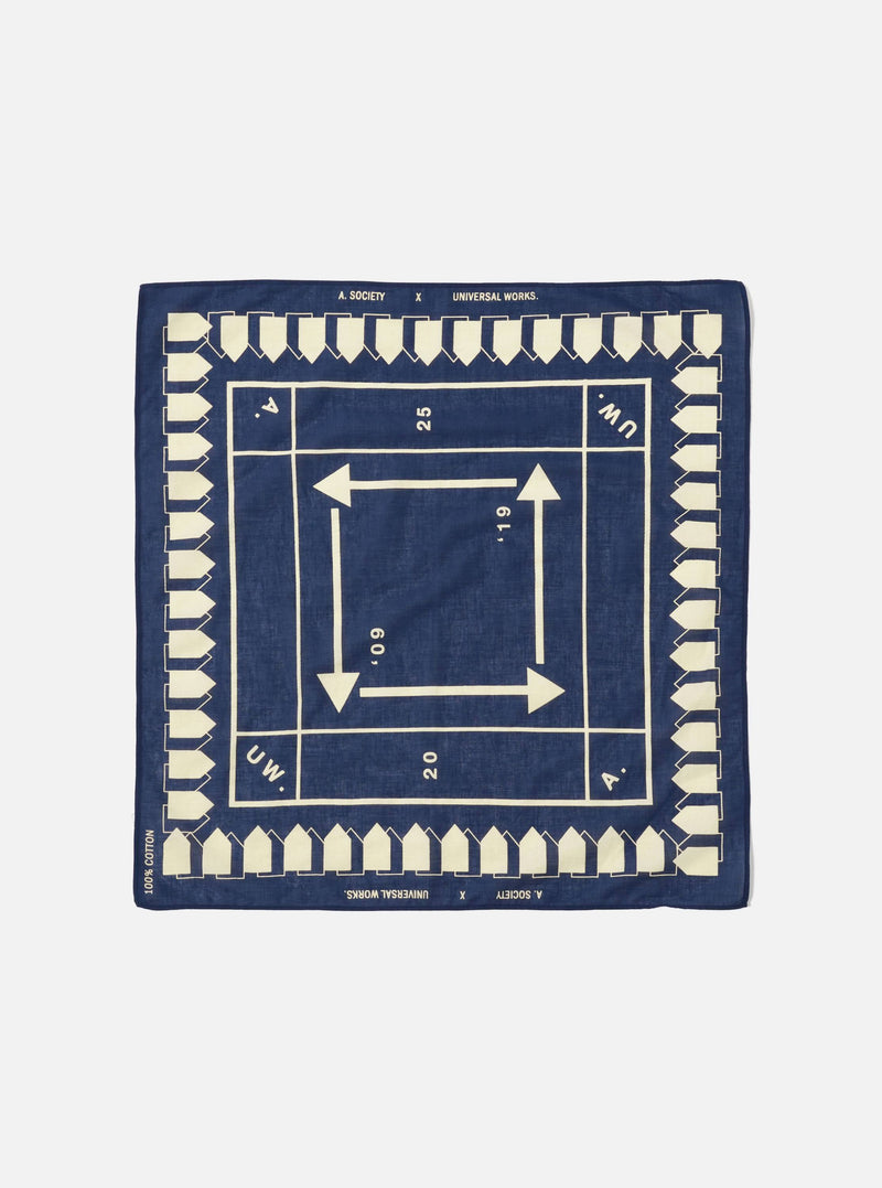 The A. SOCIETY x Universal Works Navy Cambric Neckerchief, a navy cotton square with cream arrows and house shapes. Flat lay on a white background.