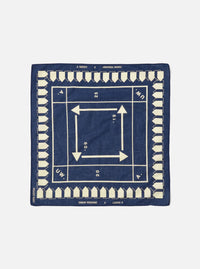 The A. SOCIETY x Universal Works Navy Cambric Neckerchief, a navy cotton square with cream arrows and house shapes. Flat lay on a white background.