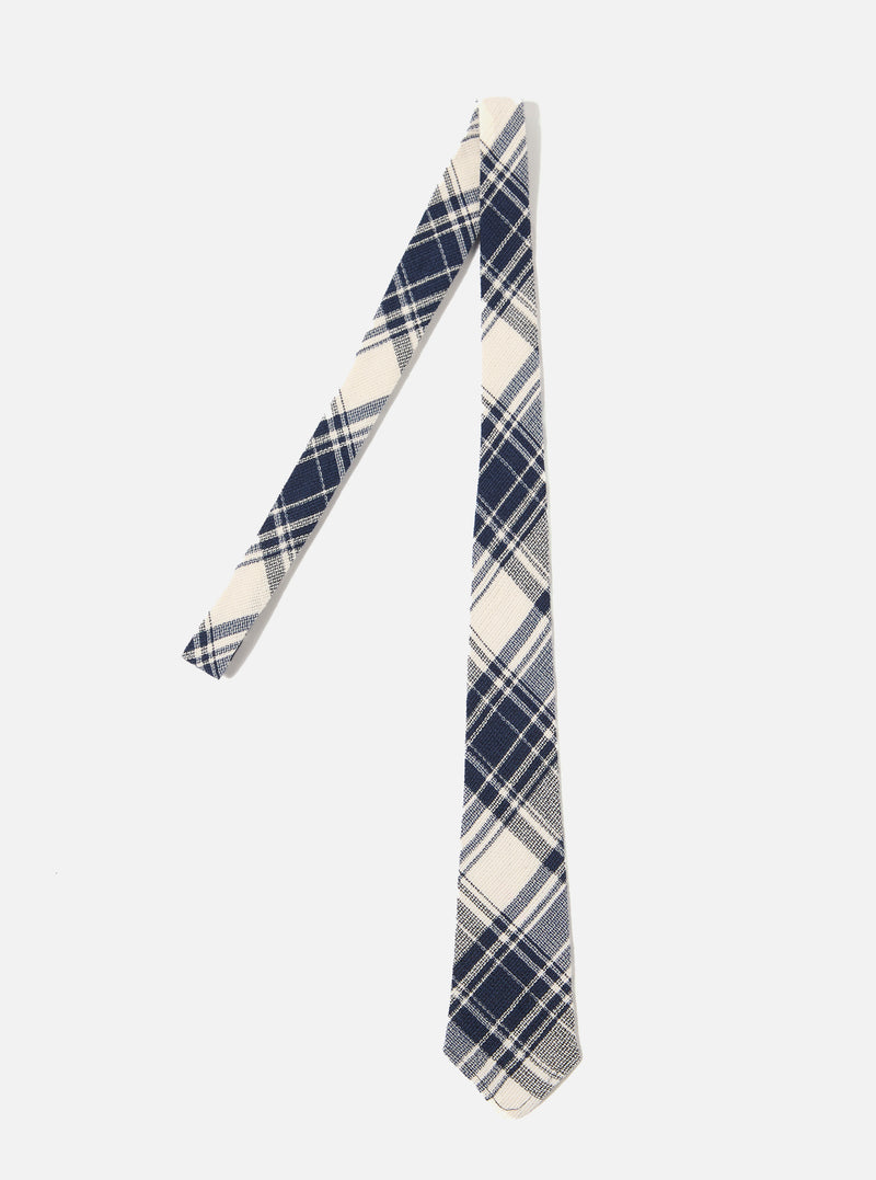 The Navy Texture Plaid Tie is shown as a flat lay against a plain white background. The tie features a bold navy and light blue plaid pattern on a textured, loosely woven cotton gauze fabric. The construction shows a standard pointed tip and a classic necktie shape.