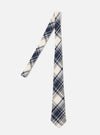 The Navy Texture Plaid Tie is shown as a flat lay against a plain white background. The tie features a bold navy and light blue plaid pattern on a textured, loosely woven cotton gauze fabric. The construction shows a standard pointed tip and a classic necktie shape.