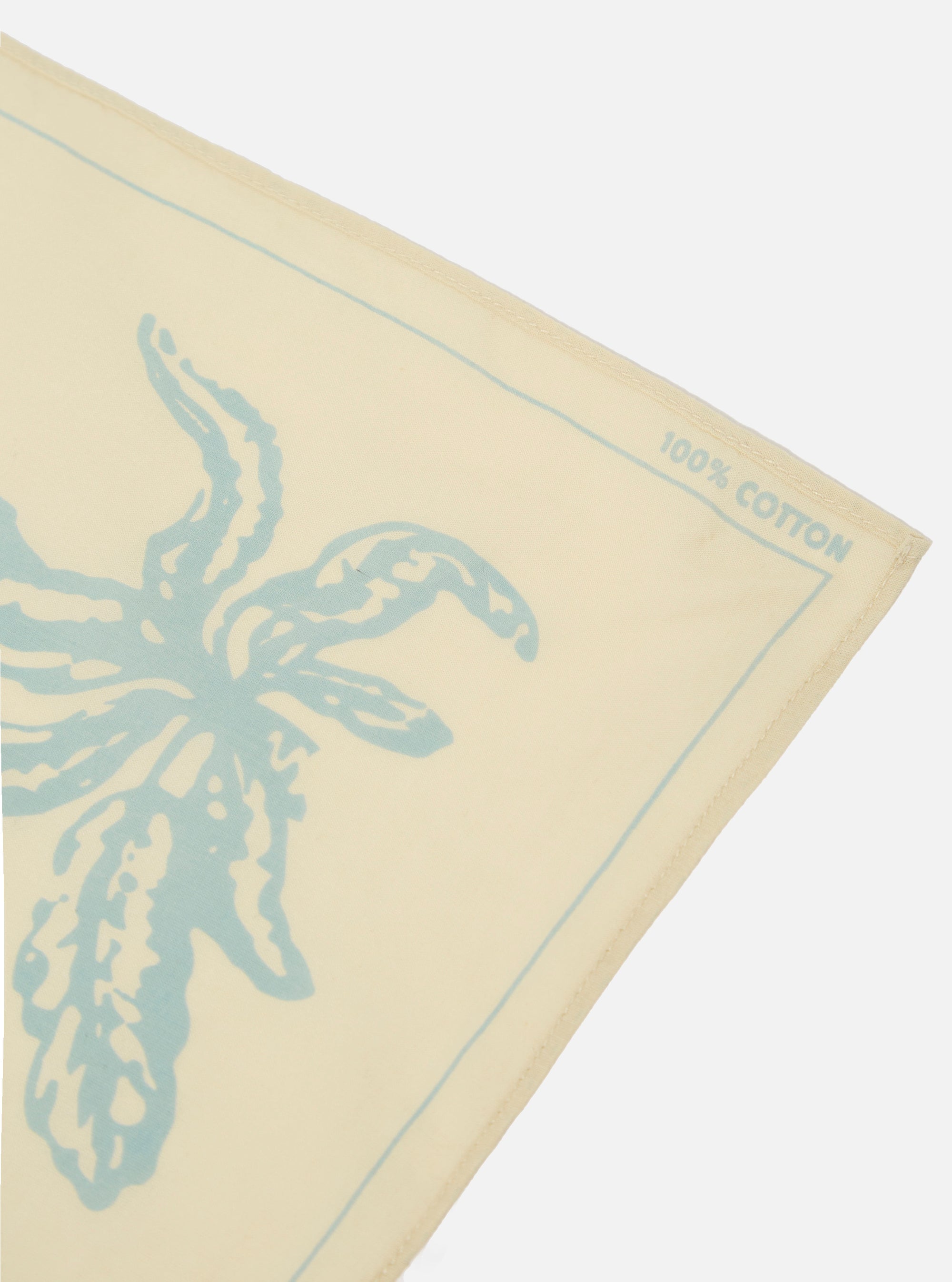 The Cream Cambric Neckerchief is shown as a flat lay against a plain white background. The neckerchief is a square of lightweight, ecru-colored cotton cambric fabric with simple hemmed edges.