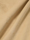 A close-up swatch of the Sand Organic Fine Cord Oxford Pant highlights the fine, vertical 21 wale texture of the organic cotton corduroy. The fabric is a solid, light sand color.
