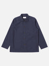 The Navy Peached Poplin Bakers Overshirt is shown as a flat lay against a white background. The overshirt features a classic collar, a central button-down closure, and four front patch pockets: one asymmetric chest pocket and three lower pockets, including a small partially concealed coin pocket. The navy cotton fabric has a soft, matte finish.