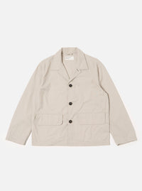 The Brown Kennedy Stripe Franck Jacket is shown as a flat lay against a plain white background. The jacket features a notched lapel, a three-button front closure, and two large patch pockets at the waist. The fabric is a brown woven cotton with a subtle Kennedy stripe pattern.