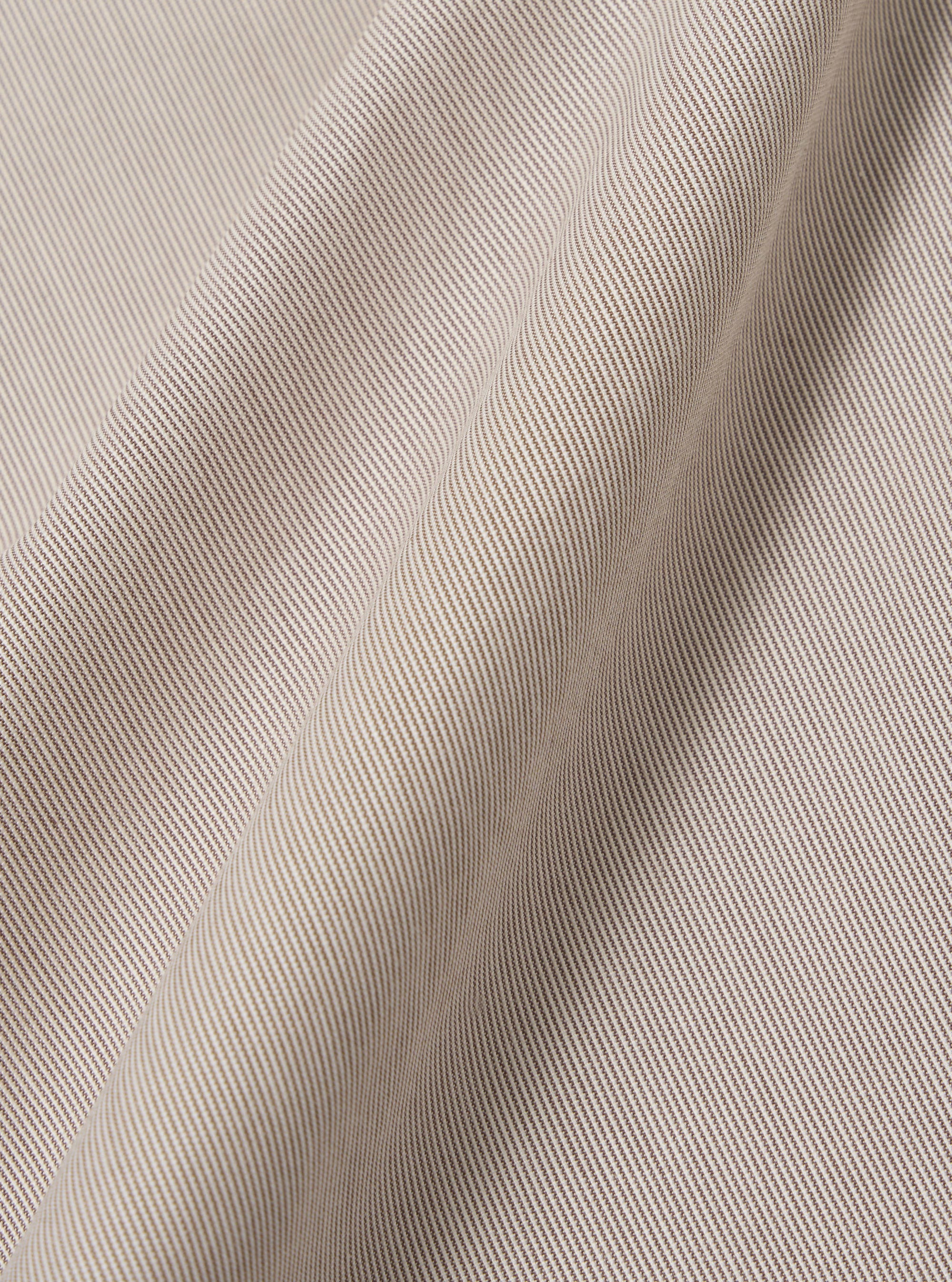 A close-up fabric swatch of the Brown Kennedy Stripe Franck Jacket highlights the brown color and the distinct vertical stripe pattern of the material.