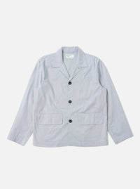 The Navy Kennedy Stripe Franck Jacket is shown as a flat lay against a white background. The jacket features a distinct vertical white stripe pattern on a navy blue cotton fabric. It has a three-button front closure, a structured collar with lapels, and two large patch pockets at the waist.