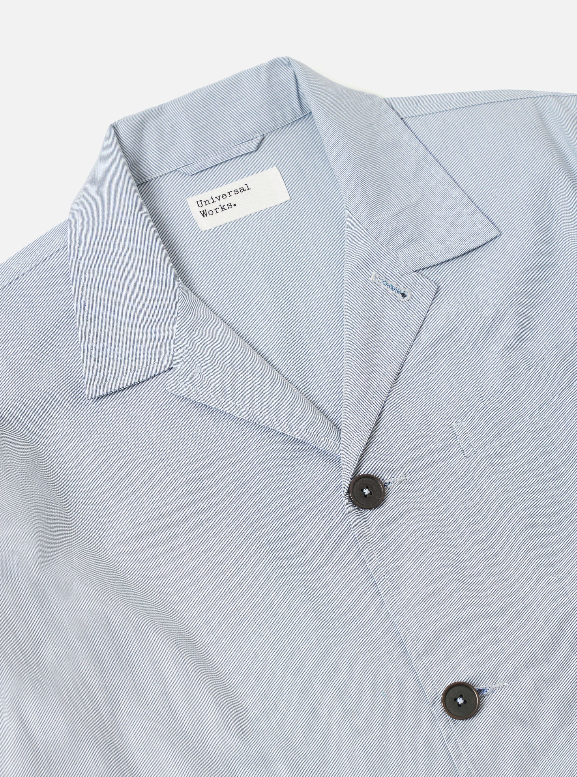 The Navy Kennedy Stripe Franck Jacket is shown from the back as a flat lay against a plain white background. The image highlights the clean lines of the jacket's rear panel, the straight hem, and the vertical pinstripe pattern on the navy cotton fabric.