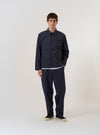 The Navy Peached Poplin Franck Jacket is shown as a flat lay against a white background. The jacket features a one-piece flat collar, a single chest pocket, and two lower flap pockets.