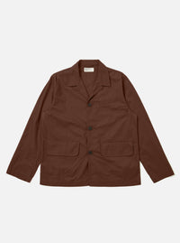 The Brown Peached Poplin Franck Jacket is shown as a flat lay against a white background. The jacket features a short, chore-style cut with a one-piece flat collar, two front flap pockets at the hips, and a single chest pocket. The smooth brown cotton poplin fabric is the primary focus.