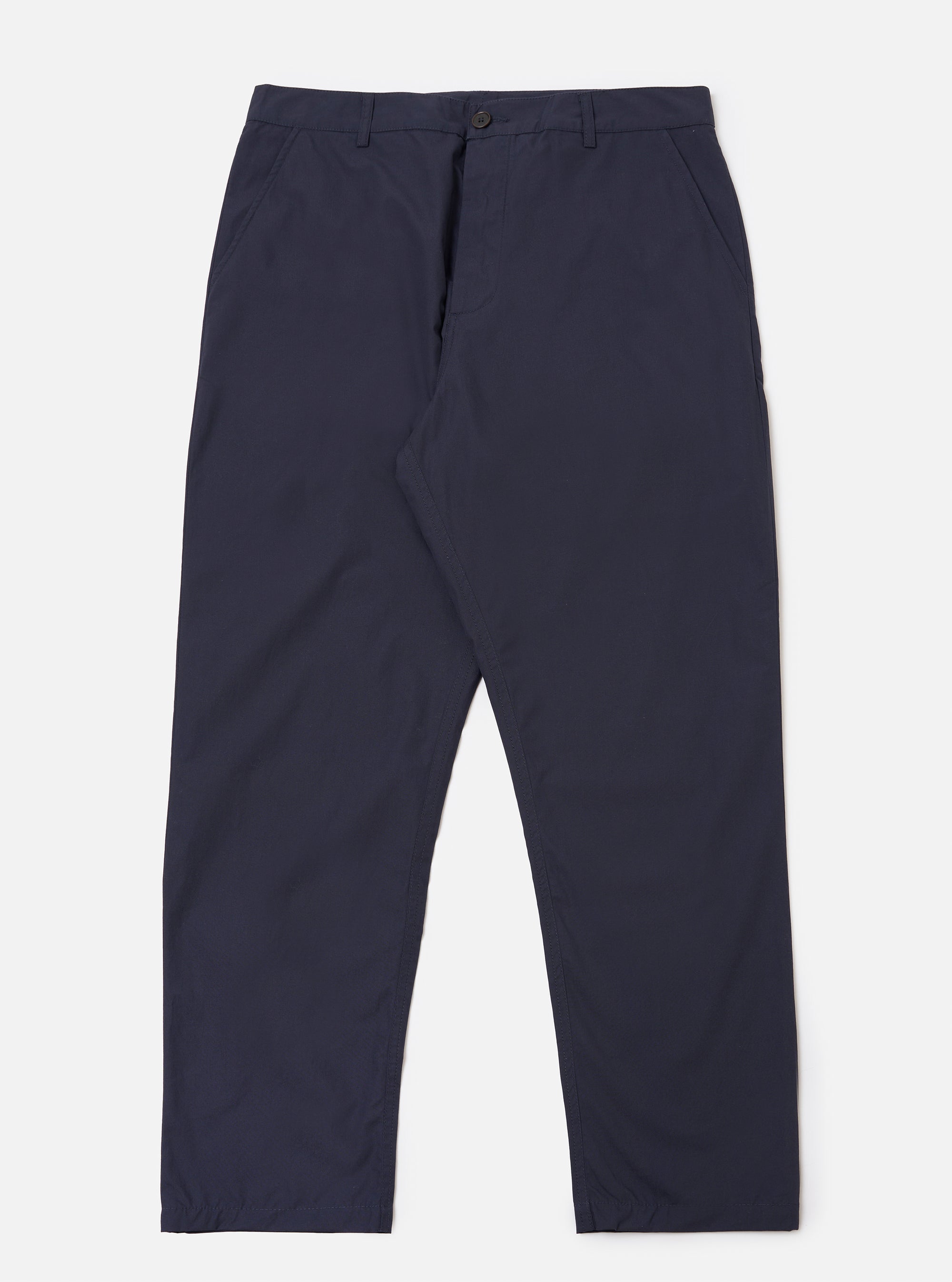 The Navy Peached Poplin Military Chino is shown as a flat lay against a plain white background. The trousers feature a mid-rise waistband with belt loops, two side pockets, and a tapered leg. The fabric is a solid navy blue cotton with a smooth, peached texture.