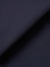 A close-up swatch image of the Navy Peached Poplin Military Chino fabric highlights the deep navy blue color and the smooth, fine-grained texture of the peached cotton poplin. The material fills the frame, providing a detailed view of the garment's color and weave.