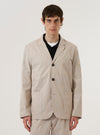 A model wears the Brown Kennedy Stripe Three Button Jacket over a light-colored shirt against a plain white background. The jacket features a prominent brown and white vertical stripe pattern, a classic three-button front closure, three large patch pockets, and a notched lapel. The model is shown from the waist up in a front-facing studio shot.
