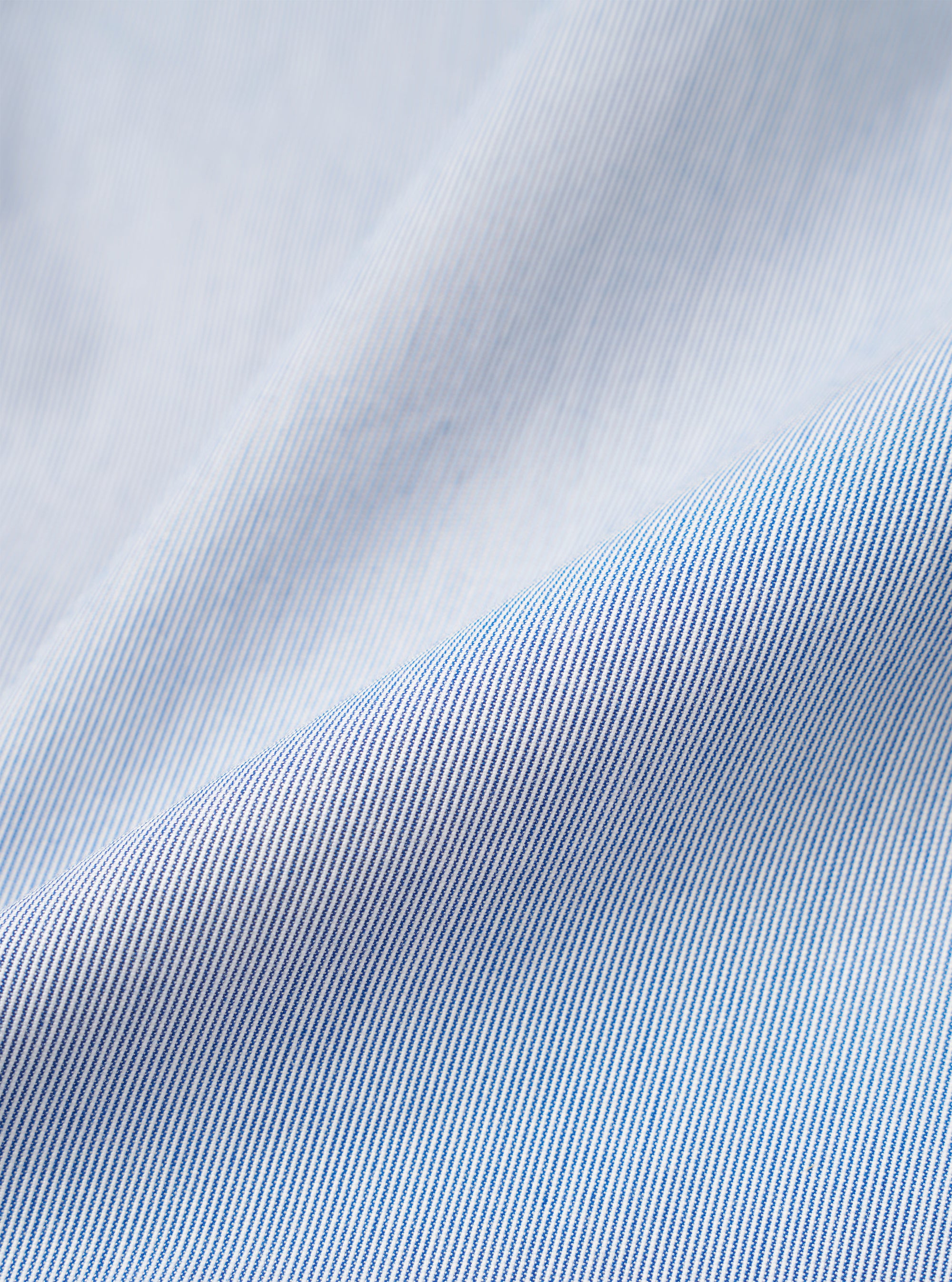 A close-up swatch image of the Navy Kennedy Stripe Three Button Jacket fabric highlights the fine vertical white stripes against a deep navy blue background. The texture of the cotton material is clearly visible, showcasing the clean lines of the pattern.