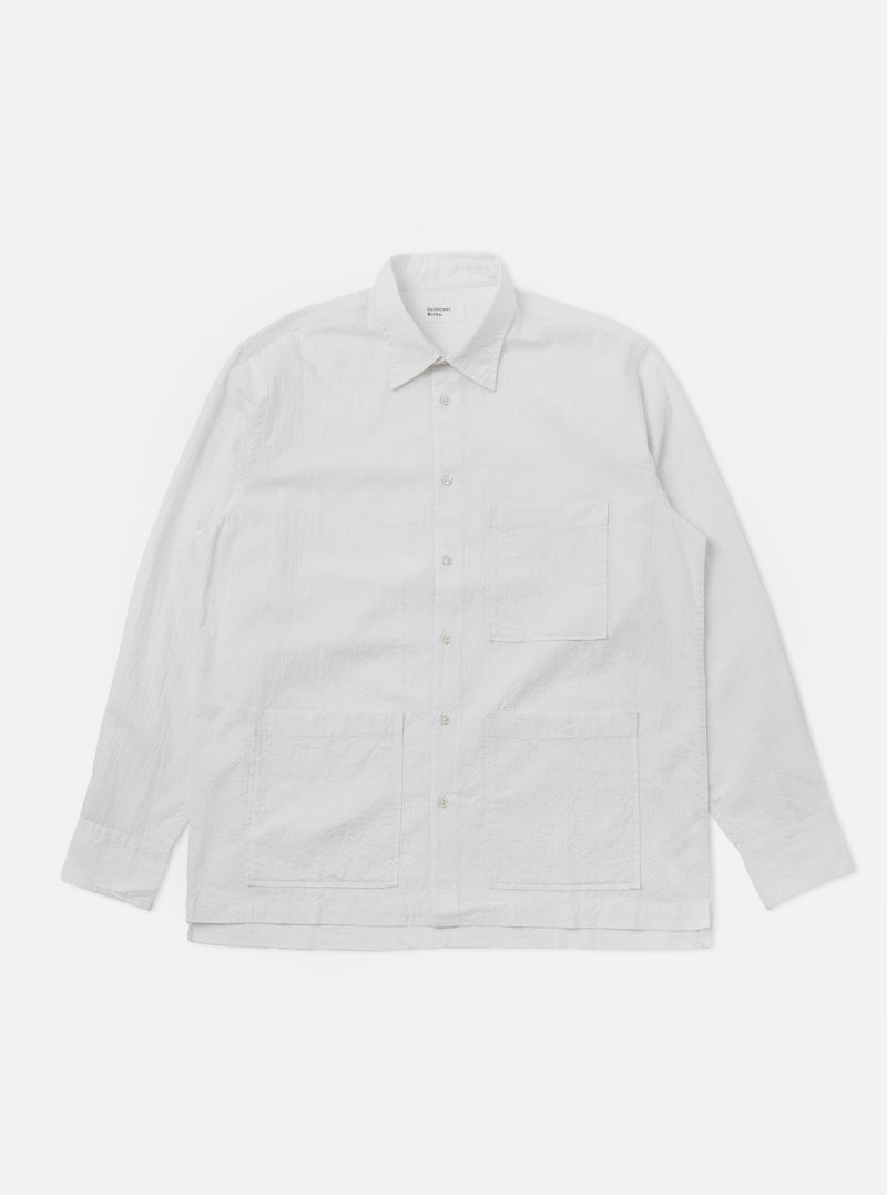 The White Seersucker Double Lucky Shirt is shown as a flat lay against a white background. The shirt features a classic button-down collar, a full-length button placket, and a single chest pocket. The fabric is made of a lightweight white cotton with a distinctive puckered seersucker texture.