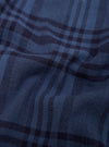 Close-up of blue plaid fabric with a focus on texture and pattern.