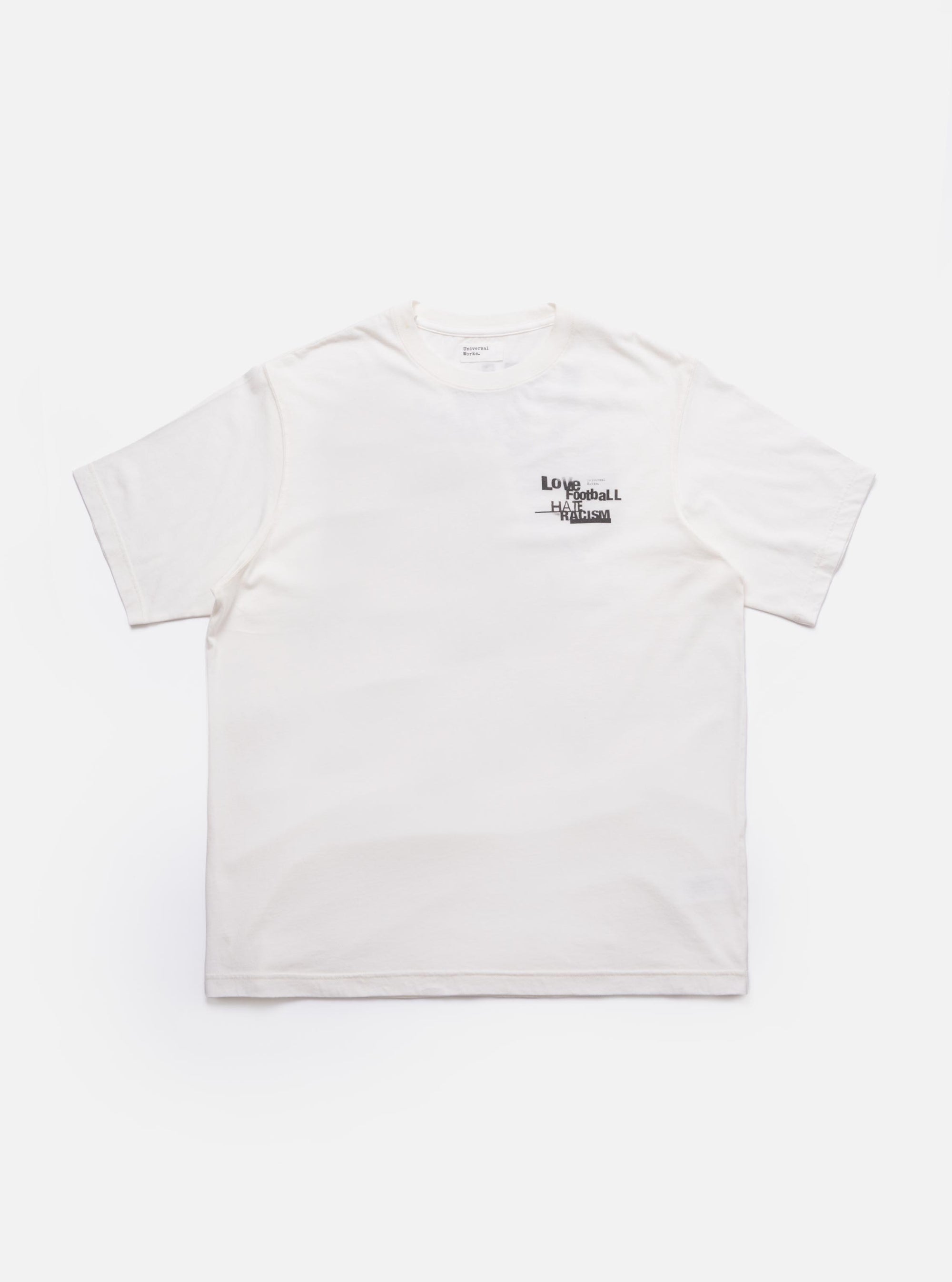The Ecru Love Football Jersey Print Tee is shown as a flat lay against a plain white background. The t-shirt is a light cream color and features a large, stylized Love graphic printed on the chest in a contrasting dark color. The garment has a classic crew neckline and short sleeves.
