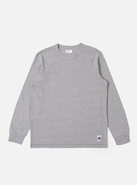 The Grey Marl Recycled/Bio Jersey Henry L/S Tee is shown as a flat lay against a white background. The long-sleeved T-shirt features a crew neckline, a straight hem, and a single patch pocket on the left chest. The fabric is a light grey marl jersey with a soft, textured appearance.