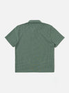 The Green Argyll Jersey Newlyn Polo is shown as a flat lay against a white background. The polo shirt features a green and white argyll diamond pattern, a three-button placket, a classic collar, and short sleeves.