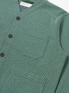 The Green Argyll Jersey Cardigan is shown from a rear angle as a flat lay against a plain white background. The image highlights the all-over green and dark-toned argyle pattern and the simple, straight-cut construction of the back panel. The cardigan features ribbed detailing at the hem and cuffs.