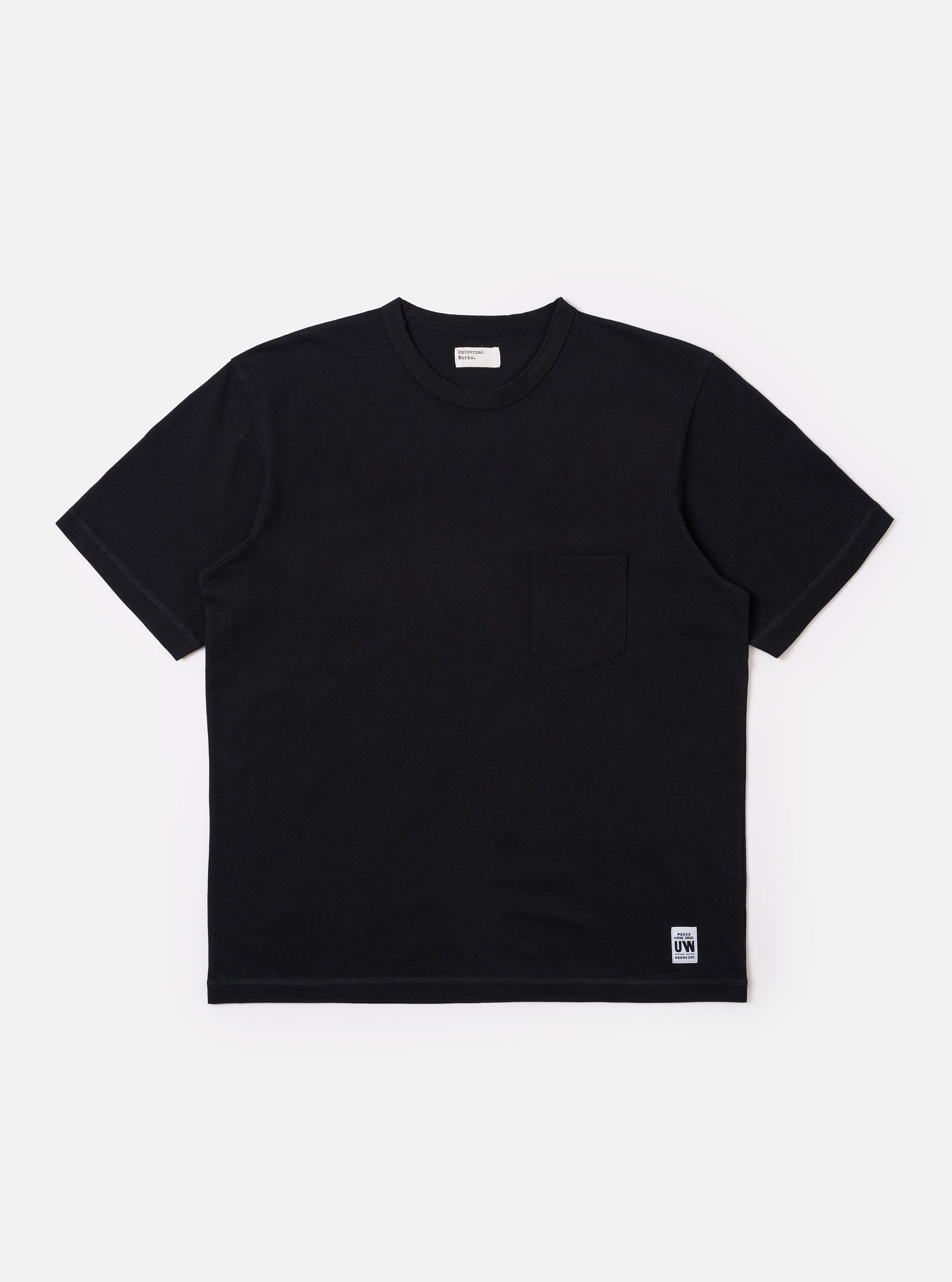 The Black Recycled/Bio Jersey Core Pocket Tee is shown as a flat lay against a white background. The t-shirt features a classic crew neck, short sleeves, and a single patch pocket on the left chest. The black jersey fabric has a smooth, matte finish.