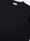 The Black Recycled/Bio Jersey Core Pocket Tee is shown from the back as a flat lay against a plain white background. The image highlights the clean, simple construction of the garment's rear and the smooth texture of the black jersey fabric.