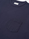 The Navy Recycled/Bio Jersey Core Pocket Tee is shown from a rear angle as a flat lay against a plain white background. The image highlights the clean, simple construction of the back panel, the ribbed crew neck, and the soft texture of the navy blue jersey fabric.