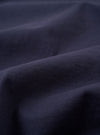 A close-up swatch image of the Navy Recycled/Bio Jersey Core Pocket Tee fabric highlights the deep navy blue color and the soft, fine knit texture of the recycled and organic cotton jersey material. The fabric fills the frame, providing a detailed view of its consistent color and smooth finish.