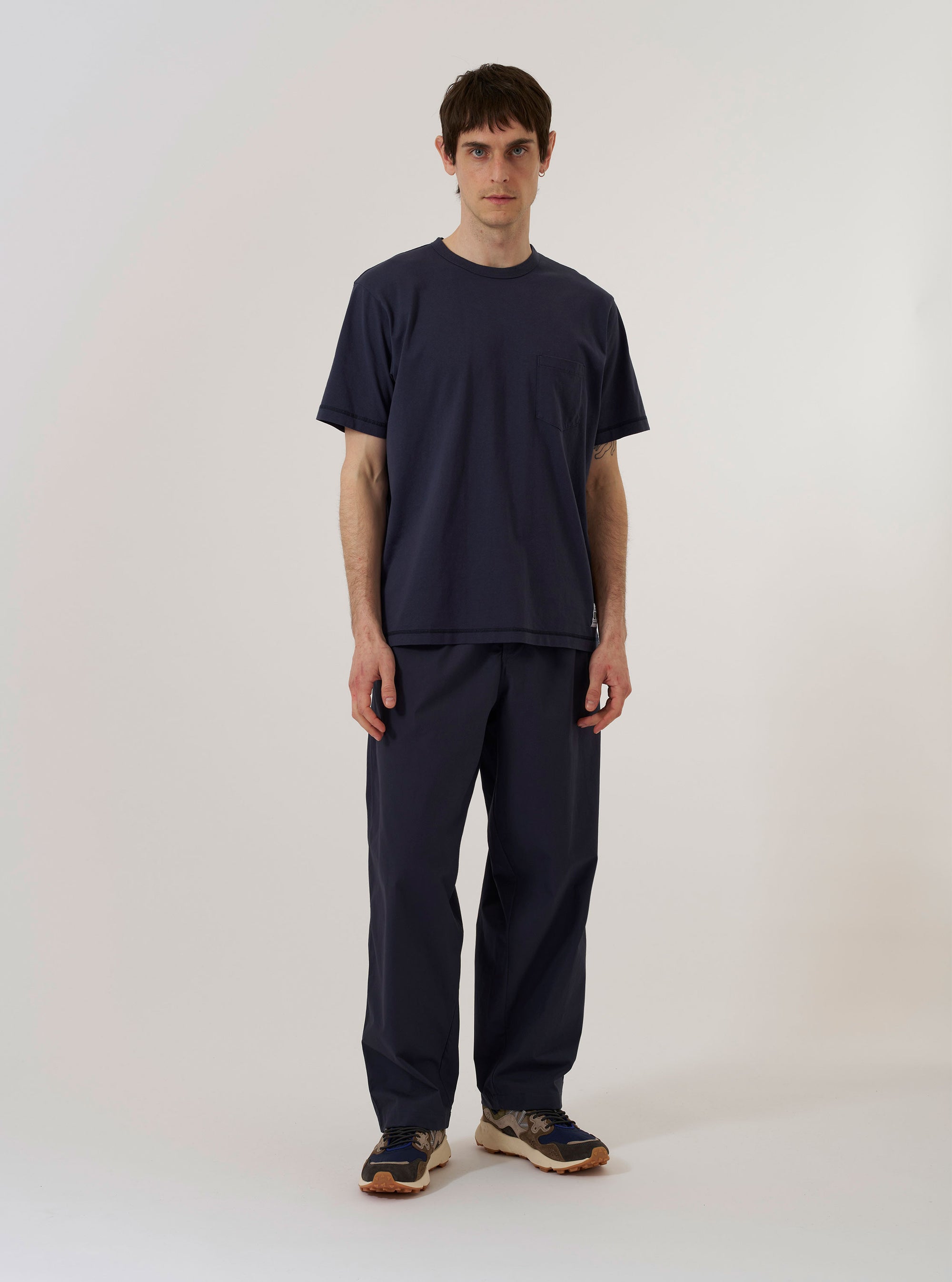 The Navy Recycled/Bio Jersey Core Pocket Tee is shown as a flat lay against a plain white background. The short-sleeve t-shirt features a crew neckline and a single patch pocket on the left chest. The fabric is a solid dark navy blue with a smooth jersey texture.