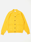 The Yellow Eco Cotton Knit Pocket David Cardigan is shown as a flat lay against a white background. The cardigan features a V-neckline, a five-button front closure, and two large patch pockets at the waist. The knit fabric has a textured, ribbed appearance in a vibrant yellow ochre color with tonal binding along the edges.