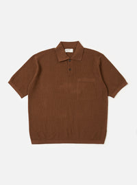 The Brown Fine Texture Tricot S/S Knit Polo is shown as a flat lay against a plain white background. The short-sleeved polo features a raised rib-patterned texture, a neat collar, a two-button placket, and a large square patch pocket on the left chest.