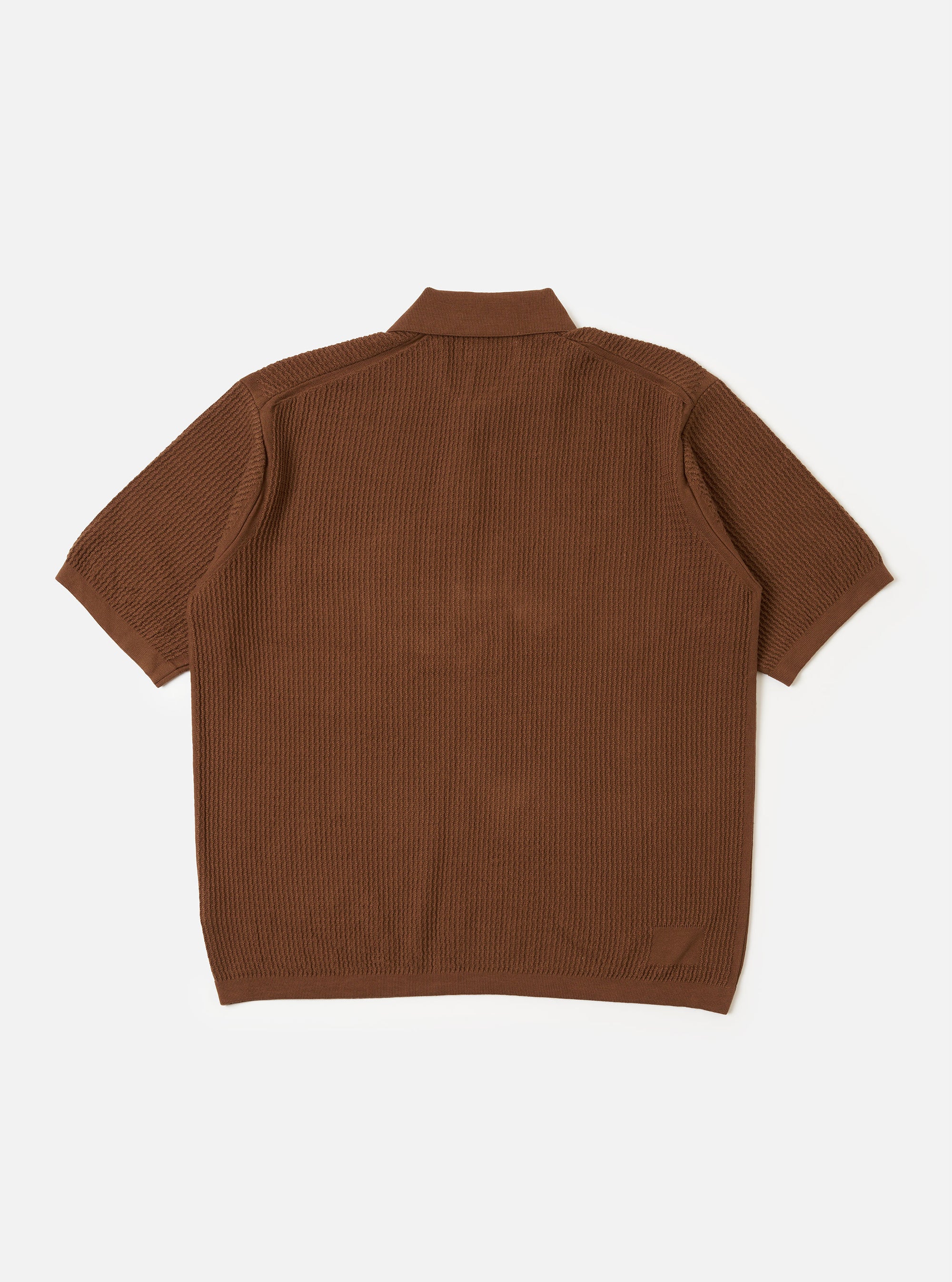 The Brown Fine Texture Tricot S/S Knit Polo is shown from the back as a flat lay against a plain white background. The image highlights the short sleeves, a neat collar, and a ribbed hem. The garment features a raised, textured rib pattern throughout the brown cotton knit.