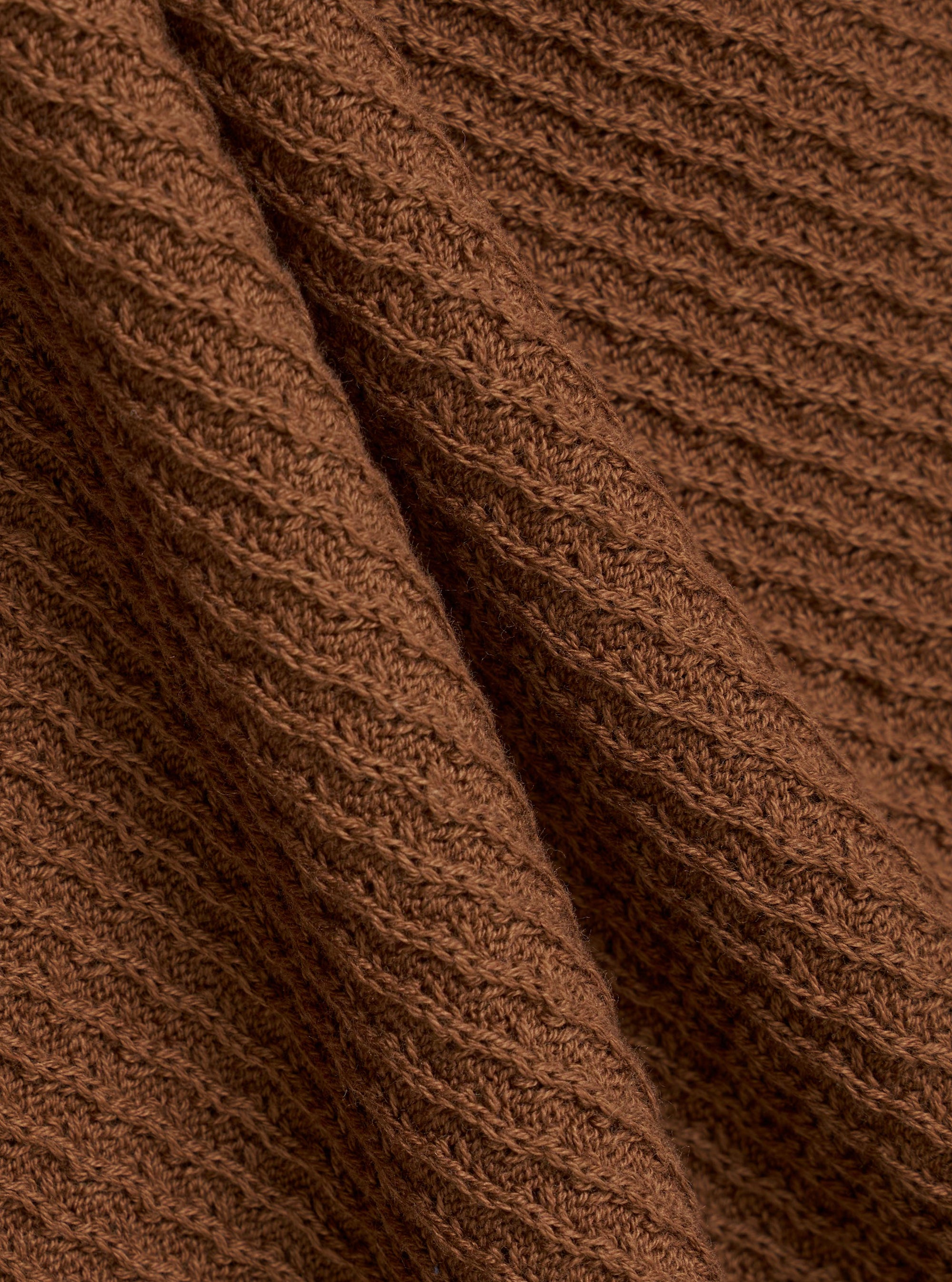A close-up fabric swatch of the Brown Fine Texture Tricot S/S Knit Polo highlights the intricate raised rib pattern and soft texture of the brown cotton knit material. The fabric fills the frame, providing a detailed view of the garment's color and technical construction.