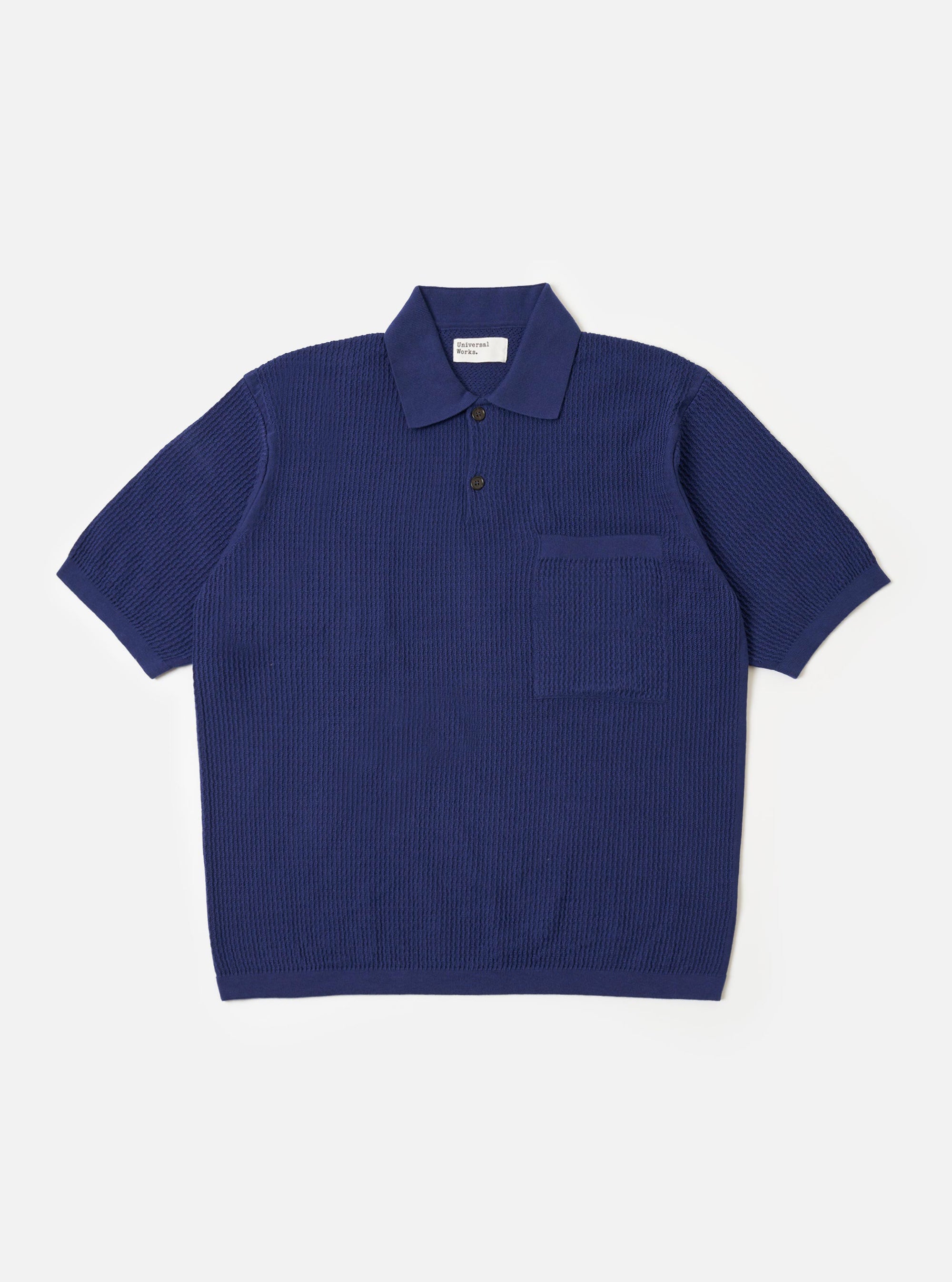 The Navy Fine Texture Tricot S/S Knit Polo is shown as a flat lay against a plain white background. The polo features a classic three-button placket, a structured collar, and short sleeves. The navy blue cotton fabric has a visible fine-textured tricot knit pattern throughout.