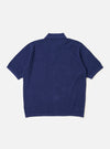 The Navy Fine Texture Tricot S/S Knit Polo is shown from the back as a flat lay against a plain white background. The image highlights the garment's intricate tricot knit texture and its loose, oversized fit. The navy blue polo features short sleeves and a clean, straight hem.