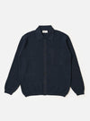 The Navy Eco Cotton Knit Jacket is shown as a flat lay against a white background. This long-sleeve knit jacket features a seven-button front closure, a fully fashioned collar, and a large square patch pocket on the left chest. Ribbed detailing is visible on the collar, cuffs, and hem.